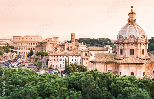 Panoramic view of the Colosseum and rooftops at sunset, Rome, Italy. © travelbook