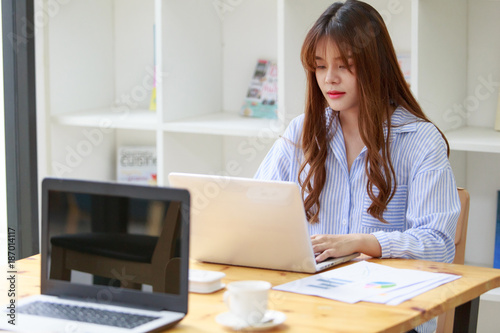 Freelancing woman using laptop computer for distance job while sitting in coffee shop. Business woman typing on laptop at workplace Woman working in home office hand keyboard.
