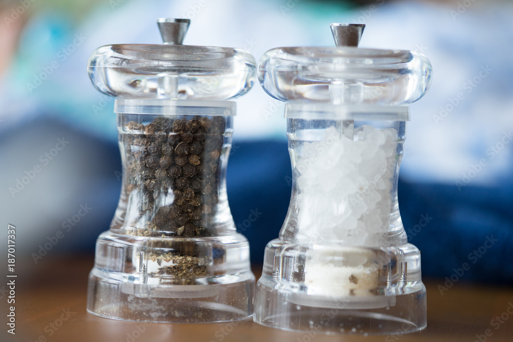 Glass salt and pepper shakers in restaurant. Glass salt and pepper shakers in restaurant.