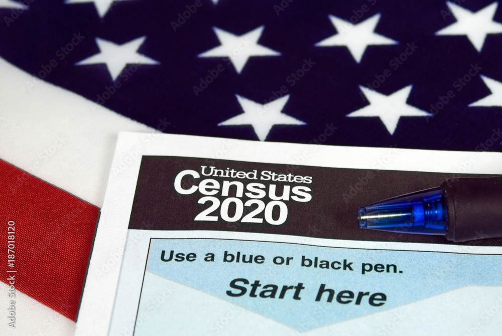 Ταπετσαρία close up of 2020 census document form and ballpoint pen on American flag