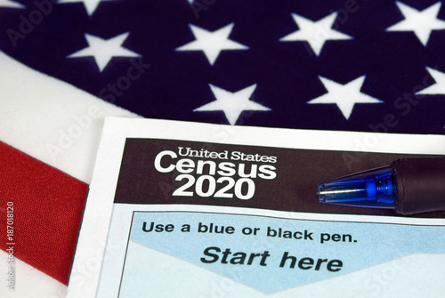 close up of 2020 census document form and ballpoint pen on American flag photo