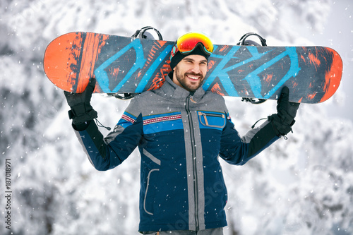 Snowboarder with snowboard in mountain