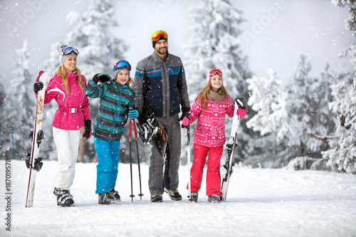 Family going to ski terrain with ski equipment