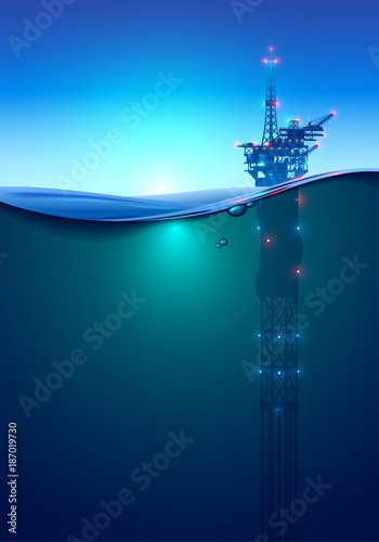 Oil offshore Drilling Platform in the ocean at dawn. Beautiful background for oil industry. Oil rig in the light of lanterns and spotlights. Split view over and under water surface. Classic spar.