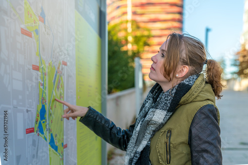 Smiling woman is studying the route map