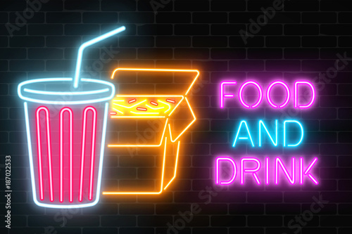 Neon food and drink glowing signboard on a dark brick wall background. Chinese noodles and plastic cup of beverage