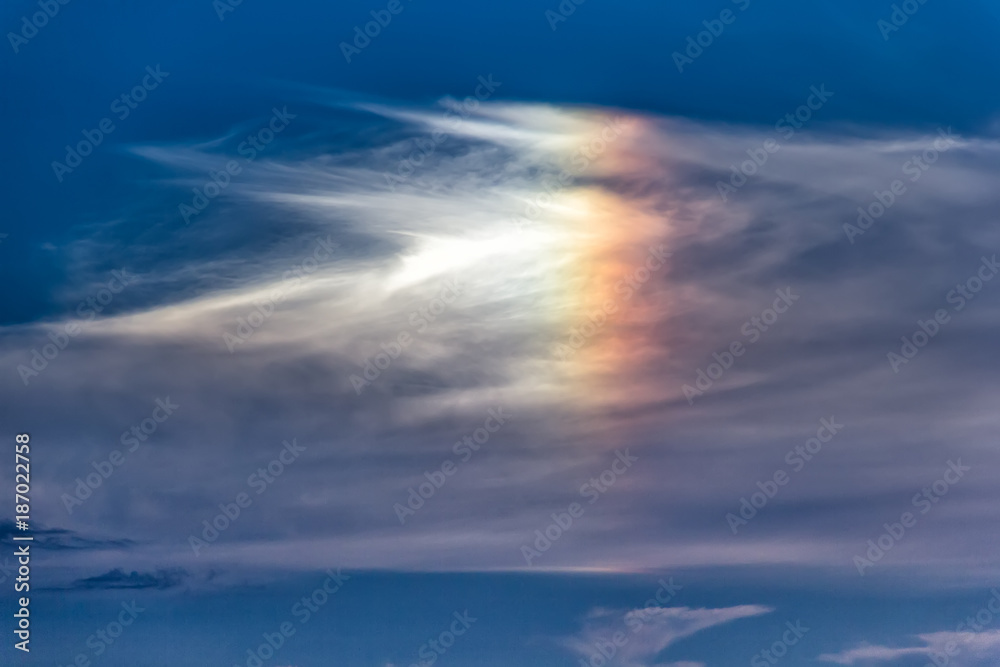 Beautiful cloudscape with a rainbow colorful cloud like a bird form