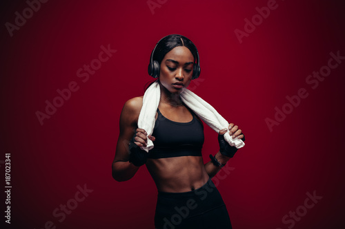 Healthy female athlete relaxing after exercising
