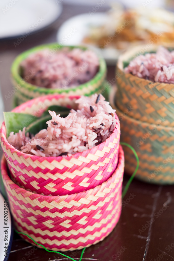 Fototapeta premium Brown sticky rice with the sticker rice wicker