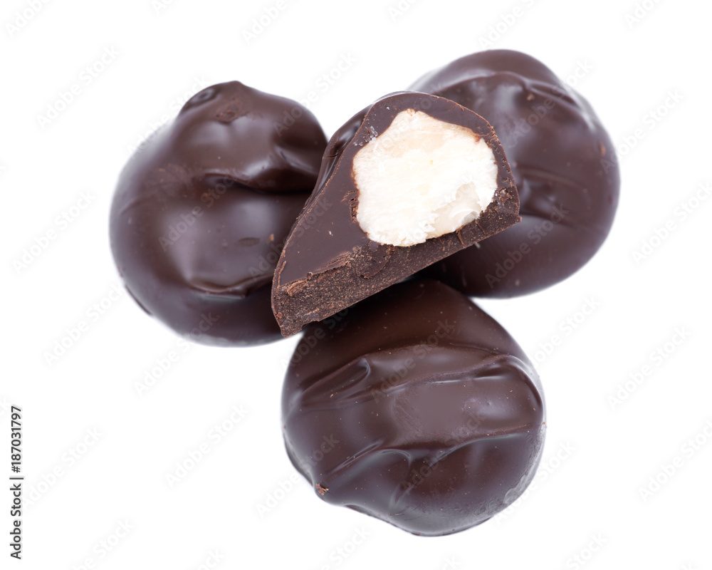 Dark chocolate covered macadamia nuts isolated on white background Dark chocolate covered macadamia nuts isolated on white background