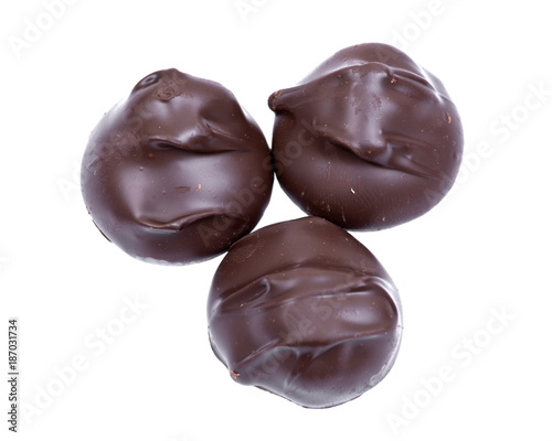 Dark chocolate covered macadamia nuts isolated on white background
