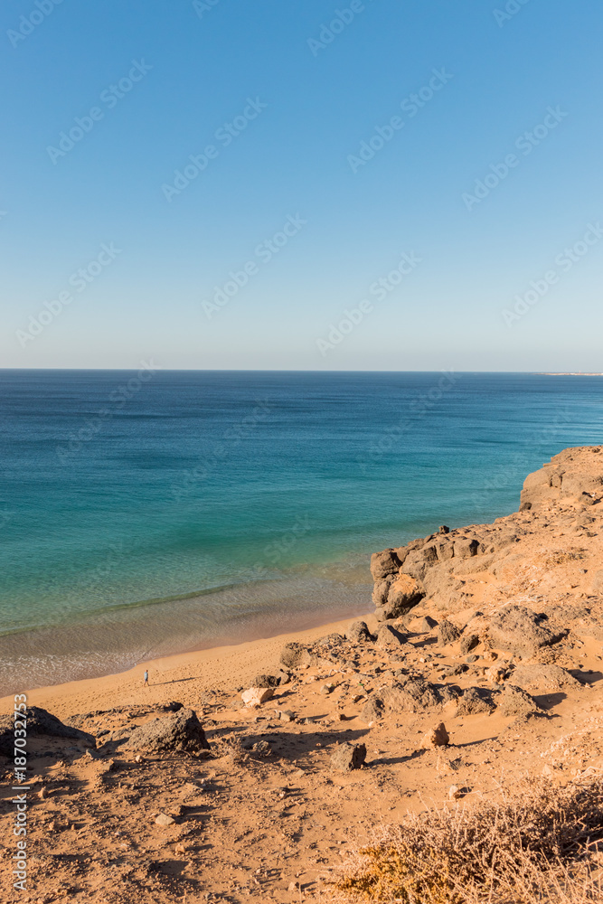 Person walking on turquoise Atlantic Ocean beach view from above, Canary Islands