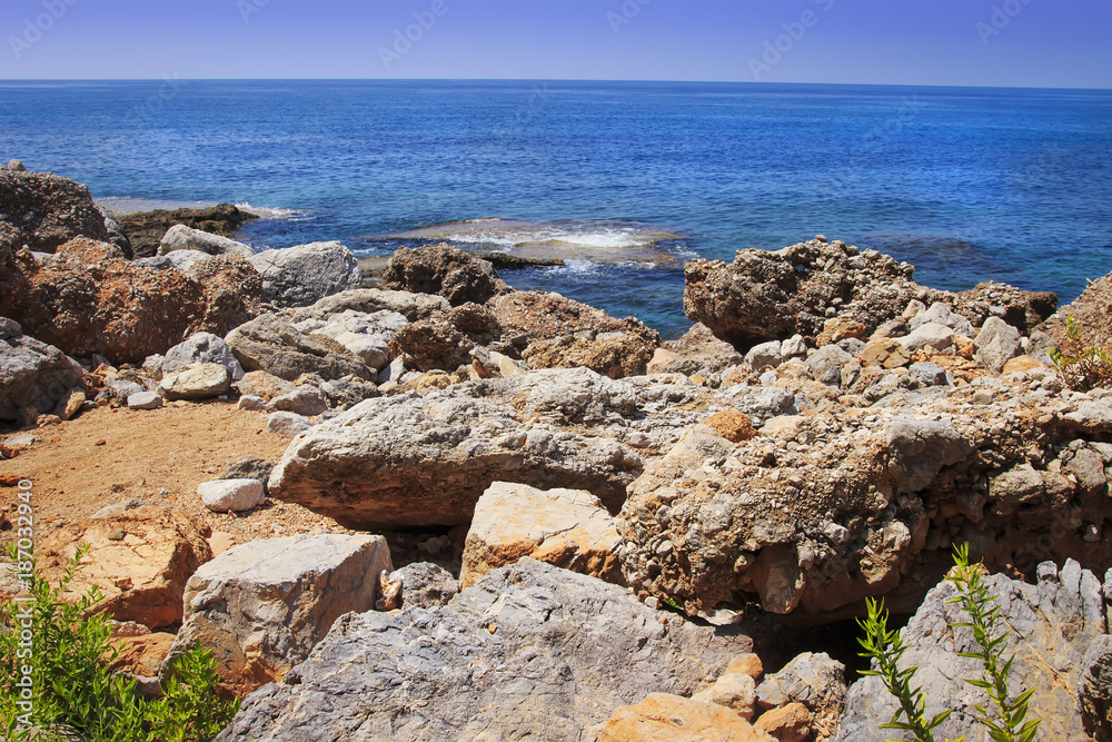 Landscape of rocky beach on blue sea. Scenery seascape on bright sunny summer day on tropical nature. Stones, rocks at coastline Landscape of rocky beach on blue sea. Scenery seascape on bright sunny summer day on tropical nature. Stones, rocks at coastline