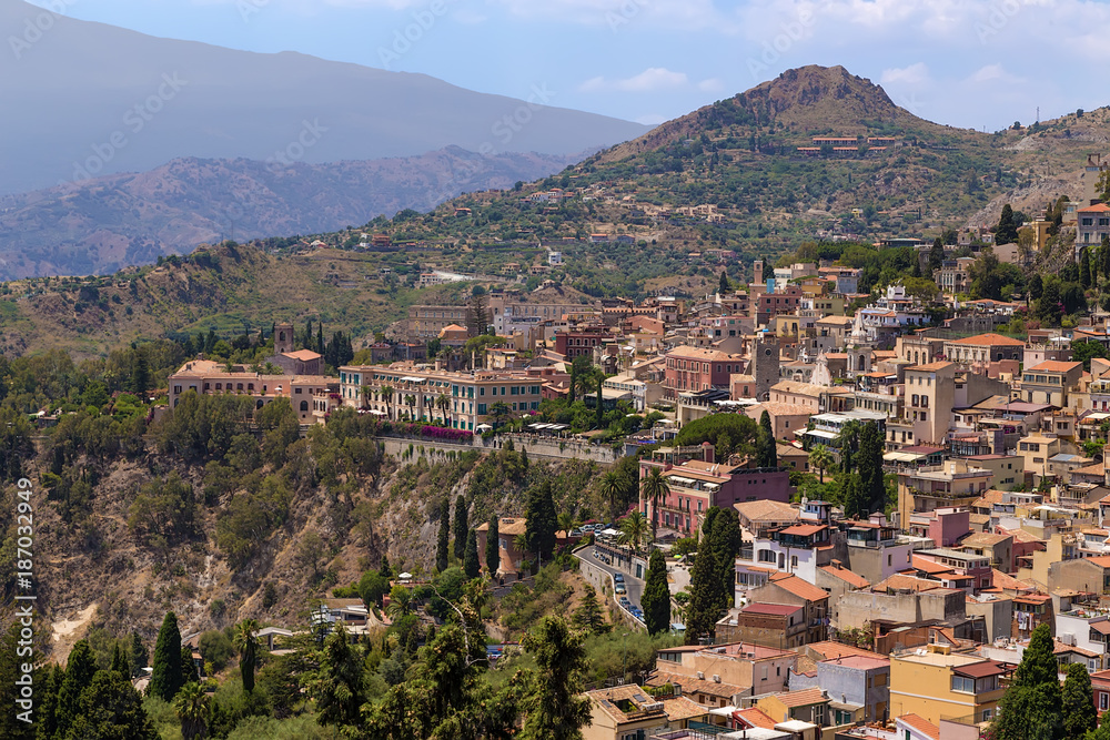 Taormina, Sicily, Italy. The historic city center in the background of the mountains
