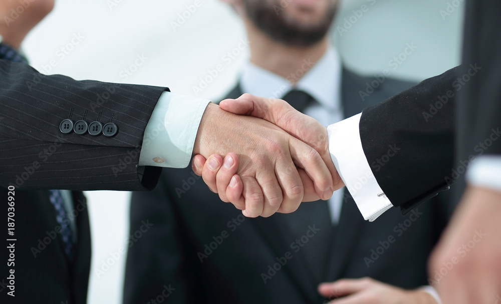 closeup handshake proven business partners