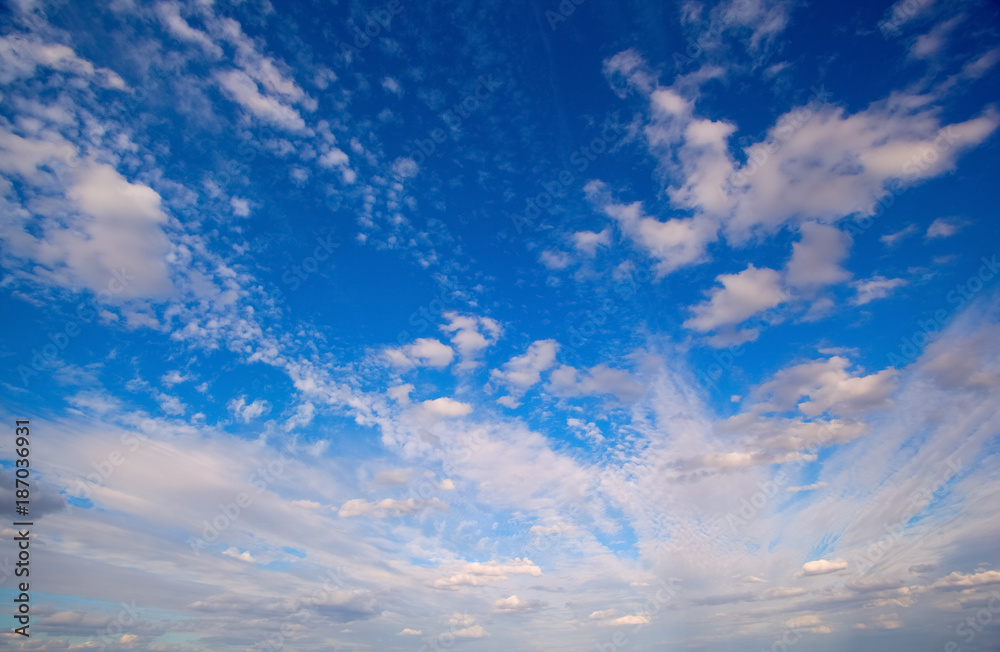 Background of a picturesque blue cloudy sky. - obrazy, fototapety, plakaty 