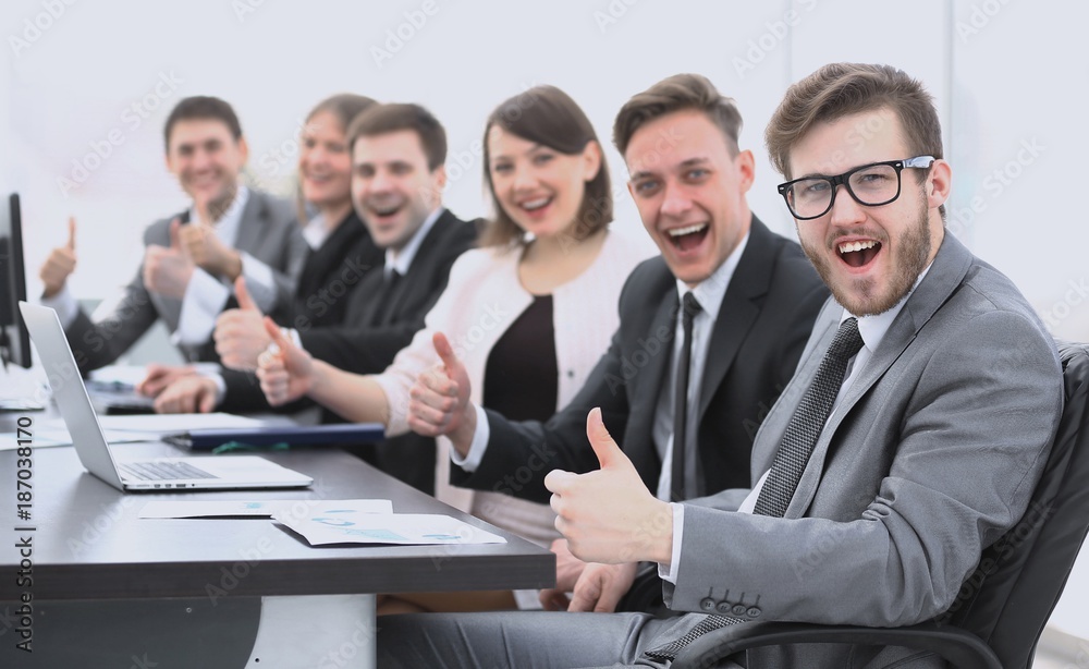 business team with thumbs up while sitting at his Desk business team with thumbs up while sitting at his Desk