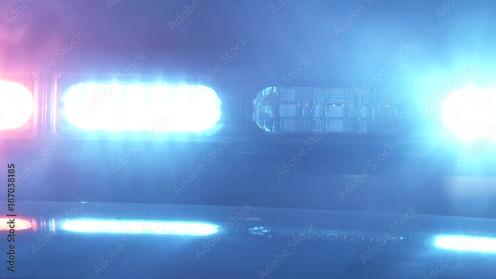 Close up on bright red and blue flashing lights from emergency vehicle with smoke blowing by. Close up on bright red and blue flashing lights from emergency vehicle with smoke blowing by.