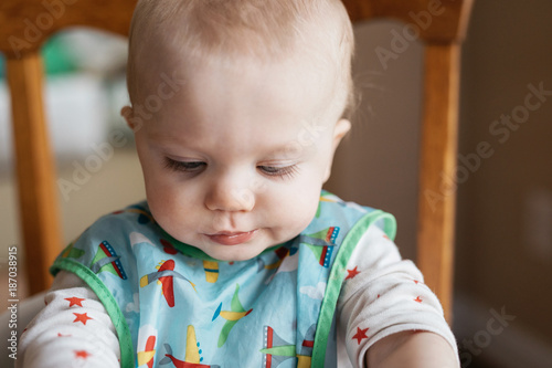 close up image of a baby wearing a bib