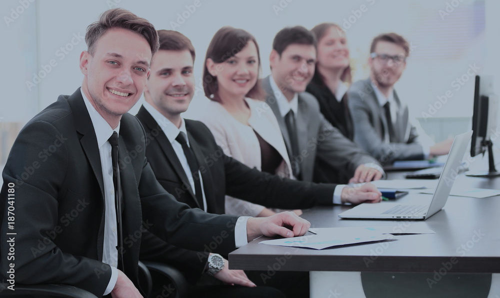 company's shareholders at a meeting at work, sitting at a table company's shareholders at a meeting at work, sitting at a table