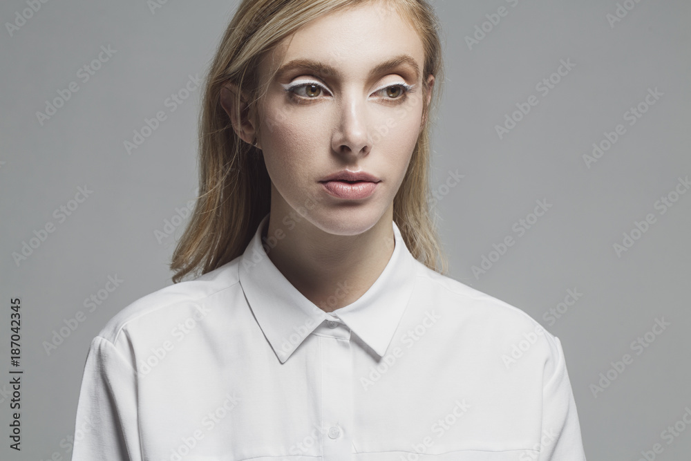 Woman standing against gray background Woman standing against gray background