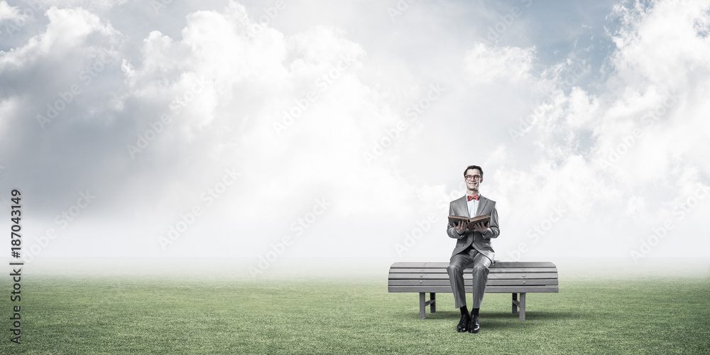 Young businessman or student studying the science in summer park Young businessman or student studying the science in summer park