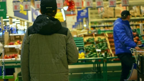 young teenager walks in the supermaket, shopping