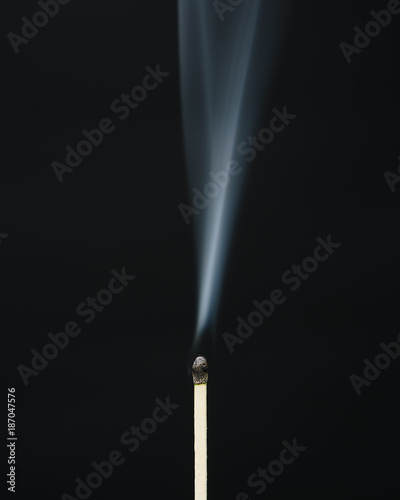 Close up of smoke rising off lit match