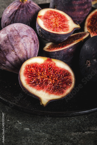 Raw fresh figs on dark stone background, copy space photo