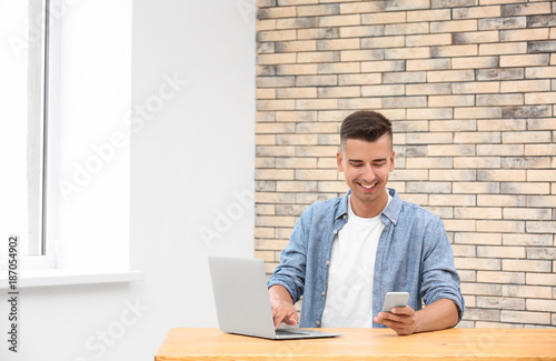 Young man using laptop and ...