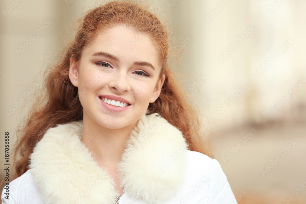 Beautiful smiling woman in jacket with faux fur collar outdoors Beautiful smiling woman in jacket with faux fur collar outdoors