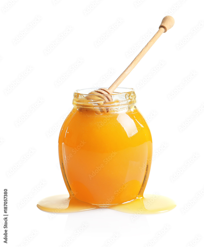 Glass jar with delicious honey and dipper on white background Glass jar with delicious honey and dipper on white background
