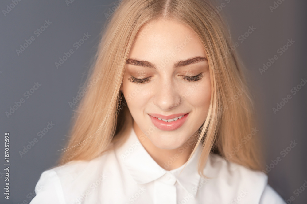 Smiling woman in white blouse on color background Smiling woman in white blouse on color background