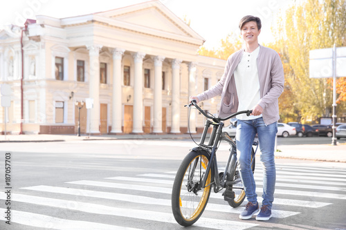Fototapeta Naklejka Na Ścianę i Meble -  Hipster teenager with bicycle on crosswalk