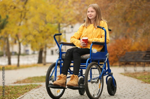 Little girl in wheelchair w...