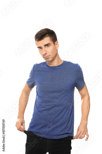 Man showing empty pockets on white background