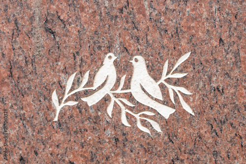 Doves and olive branch on stone surface (symbol of peace)