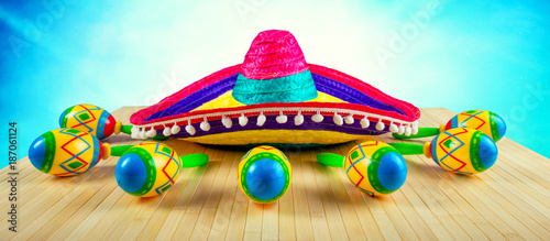 Mexico.Colored sombrero and maracas on a wooden background.	