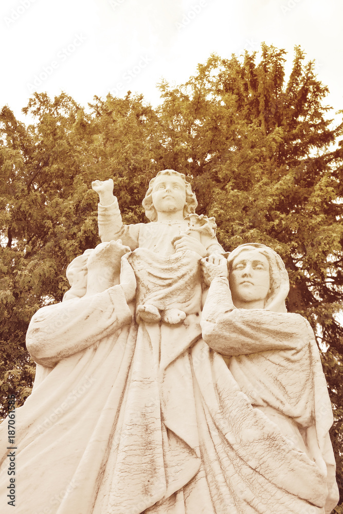 Statue depicting Christmas scene of Nativity of Jesus, with Mary and Joseph. Sculpture of the Holy Family of Jesus. Parents holding the child on their hands.