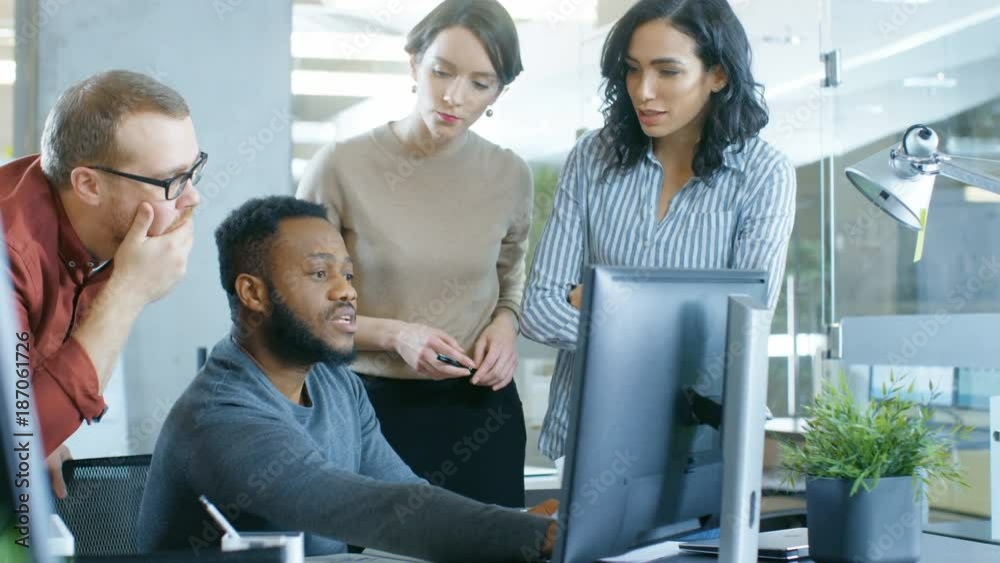 In the Busy Corporate Office Team of Diverse Young Creative People Work on a Problem Solution. Collectively They Try to Help Coworker to Solve Problem. Shot on RED EPIC-W 8K Helium Cinema Camera.