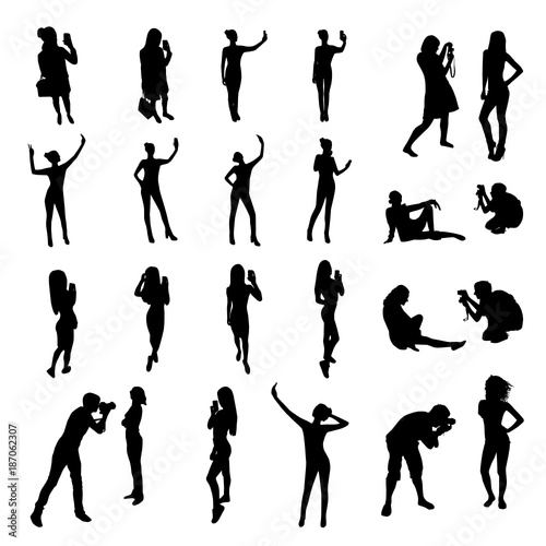 People silhouettes posing for photograph and taking selfie