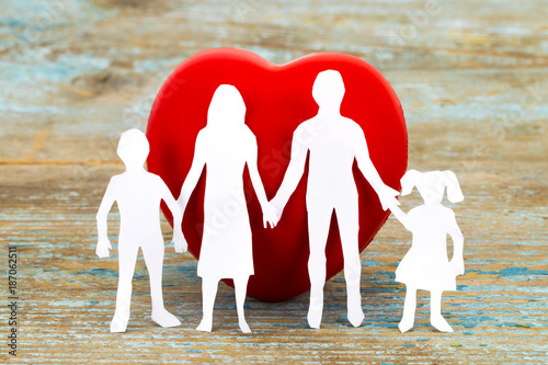 Obraz na płótnie Paper silhouette of family and heart on wooden background. Health insurance concept w salonie