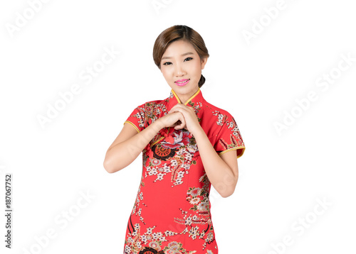 Asian woman in Chinese dress traditional cheongsam with gesture of congratulation in Chinese new year isolated on white background with clipping path.. photo