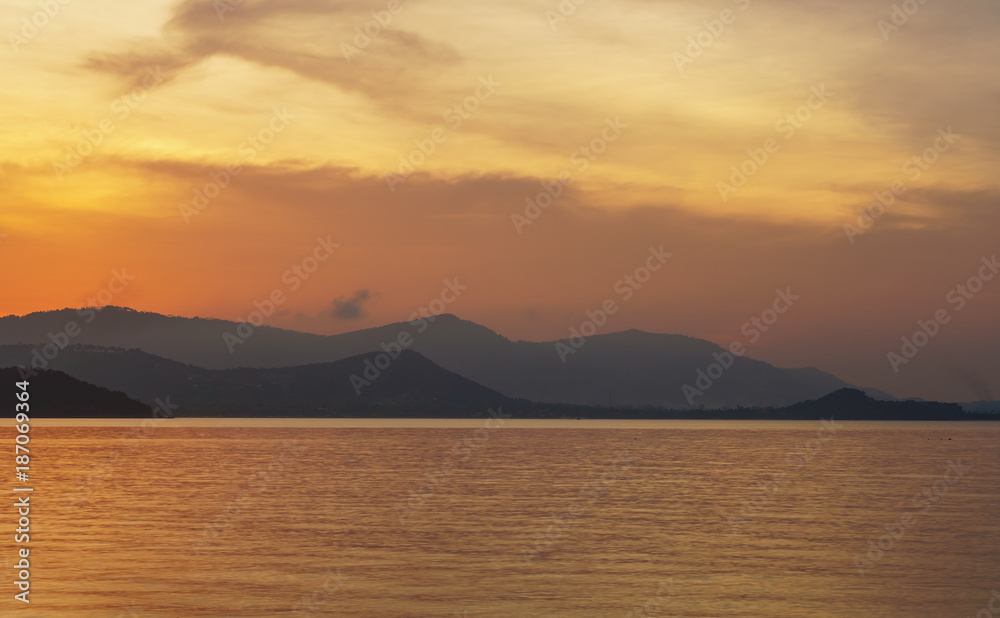 Colourful sunset over sea lagoon and mountains 