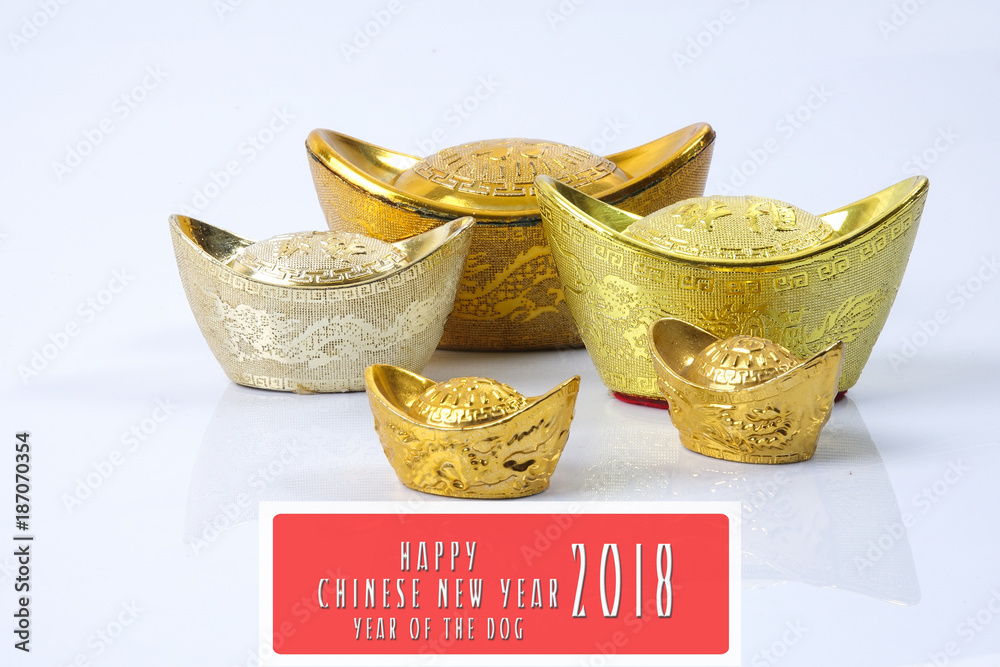 Fototapeta premium Chinese new year festival decorations, gold ingots isolated on white. Chinese characters means luck,wealth and prosperity. HAPPPY CHINESE NEW YEAR 2018