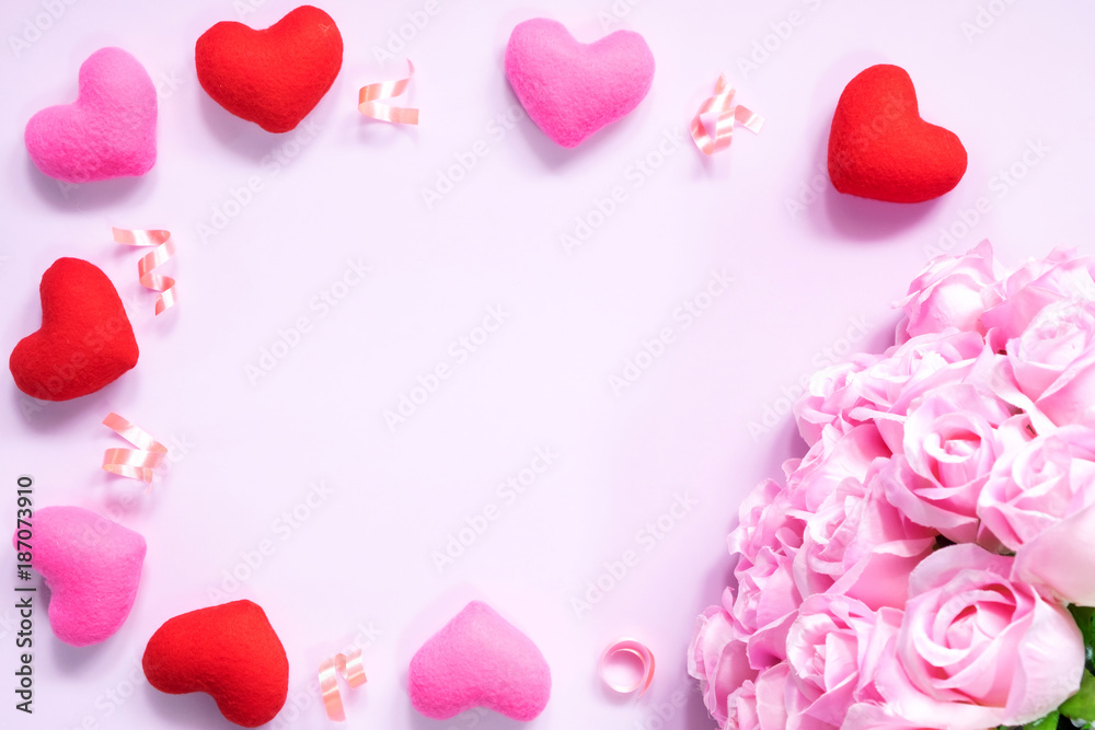 Top view of flat lay decoration Romantic, St valentine's day concept with valentines mini pin heart with pink rose flower on pink background with copy space minimal style.