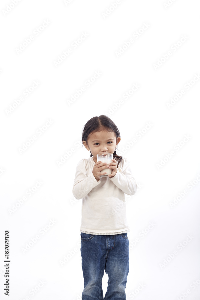Preschool girl holding a glass with milk Preschool girl holding a glass with milk