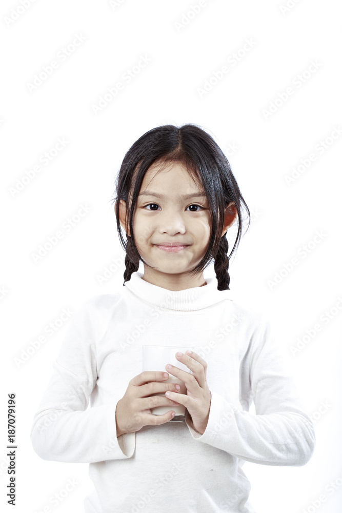 Preschool girl holding a glass with milk Preschool girl holding a glass with milk