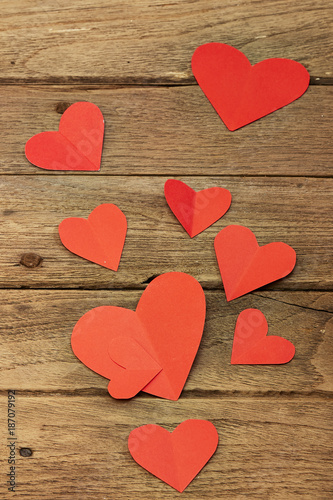Red heart paper on wooden background