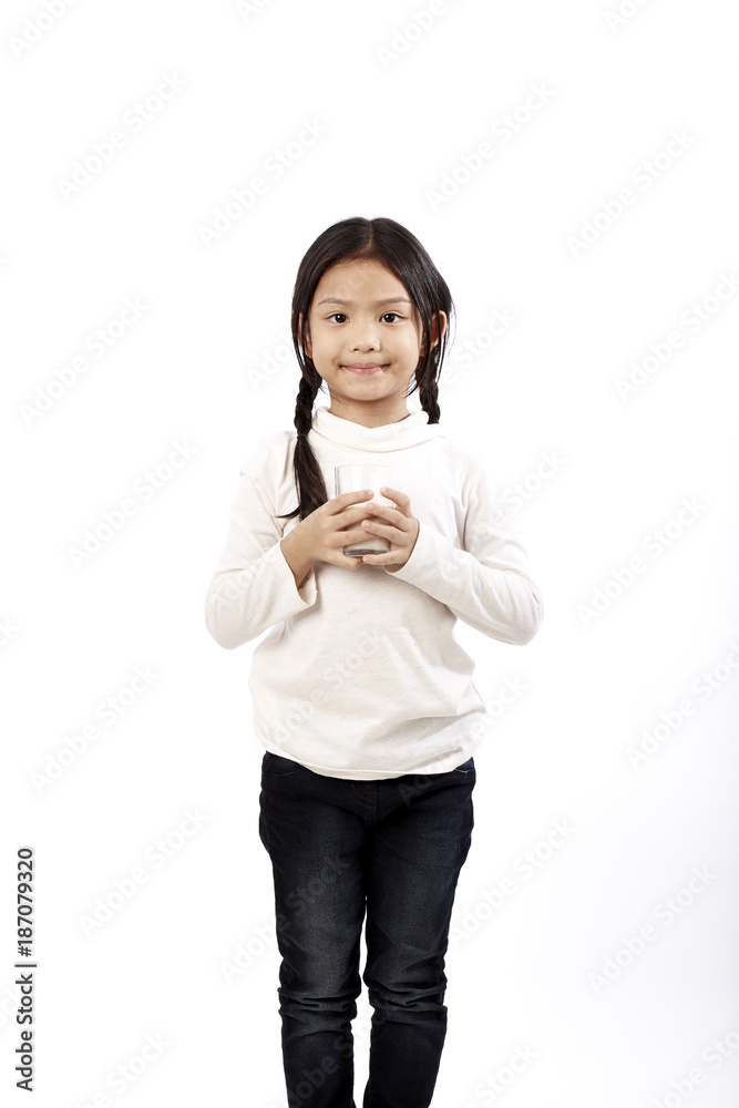 Preschool girl holding a glass with milk Preschool girl holding a glass with milk